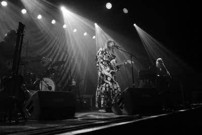 A band performs to a crowd on stage
