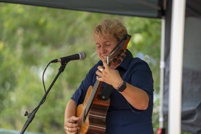 skarlett woods playing acoustic guitar and singing