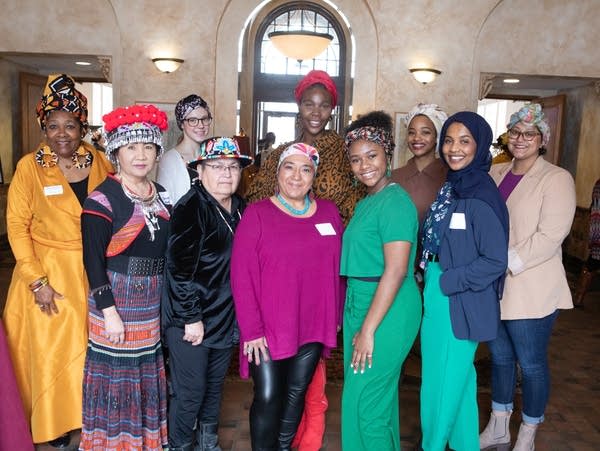 A group of women in headscarves pose for a portrait
