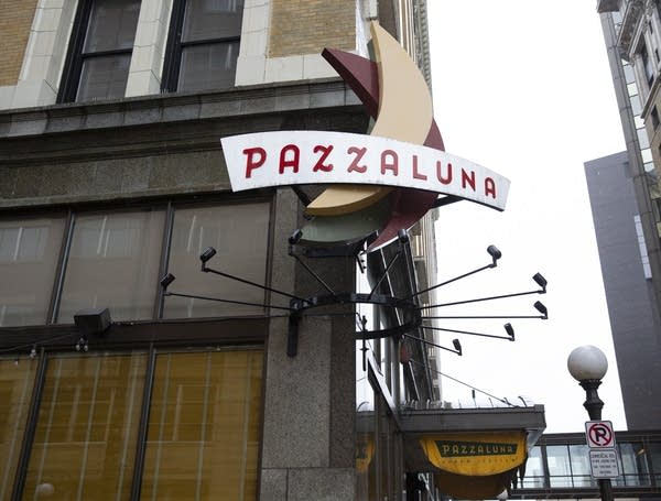 A sign on a building reads "Pazzaluna"