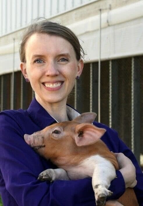 woman holding piglet