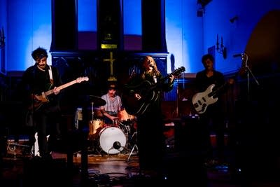 A band performing onstage in a music venue