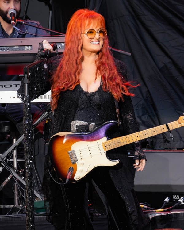 Wynonna Judd smiling on stage