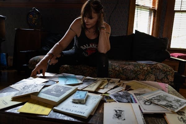 A woman looks at a table full of zines