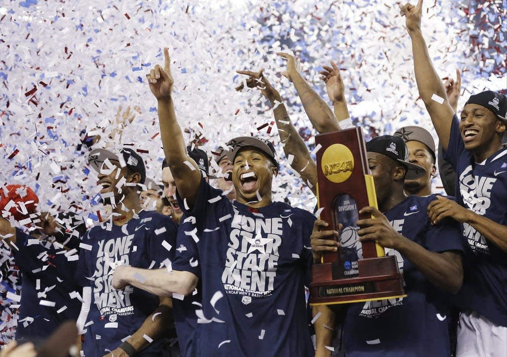 UConn celebrates with the championship trophy