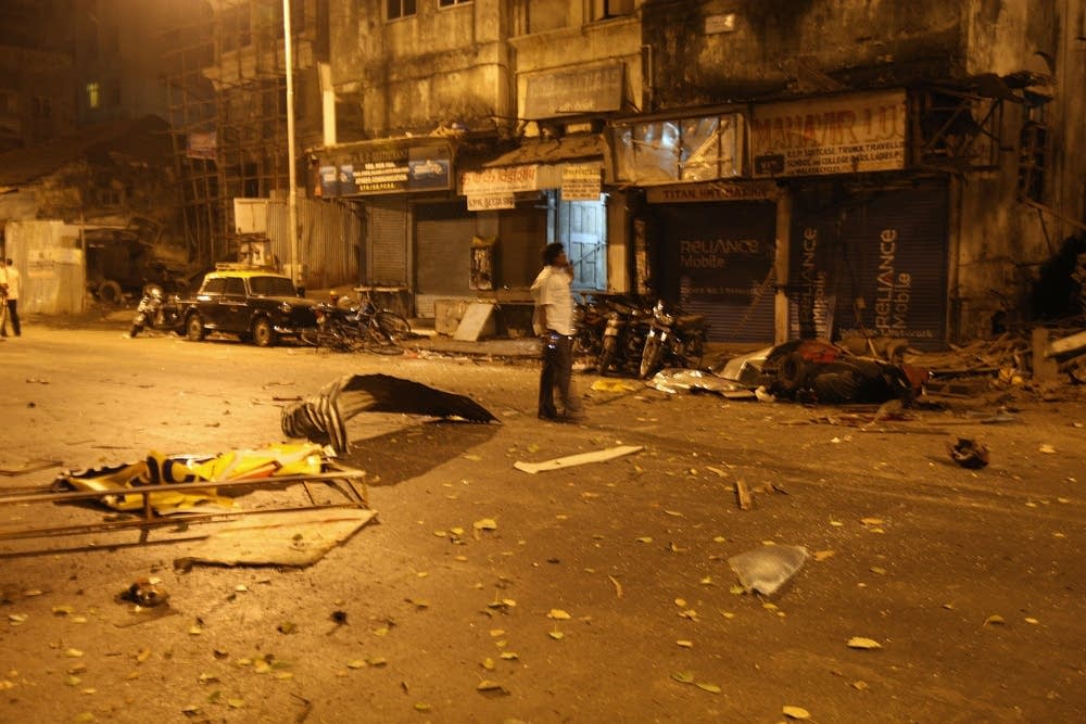 An Indian man stands at the site of an attack