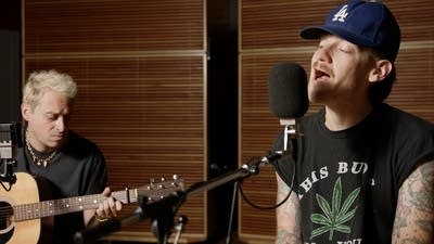 Two musicians perform together in a recording studio