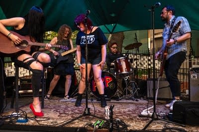 a rock band performing on an outdoor stage