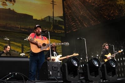Nathaniel Rateliff and his band performing on stage