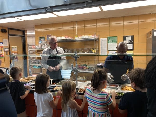 Two people serve lunch