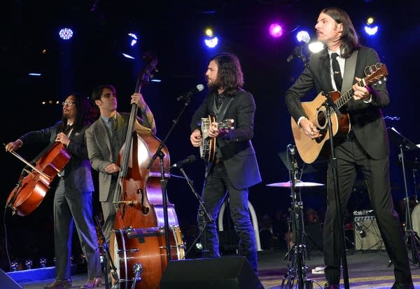 Joe Kwon, Bob Crawford, Scott Avett and Seth Avett of the Avett Brothers performing onstage