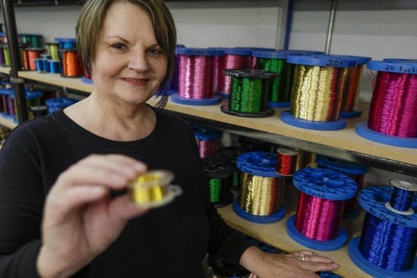 Edie Ramstad shows a six-ounce spool of wire.