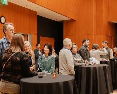 People gather and converse at a social event