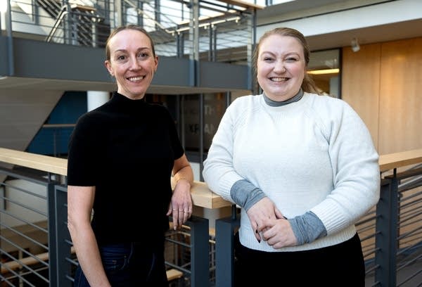 two women pose for a portrait