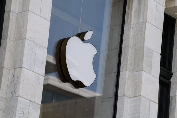 The Apple logo is seen at the entrance of an Apple store in Washington, DC, on September 14, 2021. - Apple users were urged on Tuesday to update their devices after the tech giant announced a fix for a major software flaw that allows the Pegasus spyware to be installed on phones without so much as a click.