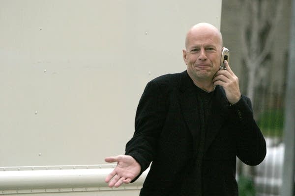 A photo of actor Bruce Willis on the phone in the 2000s.