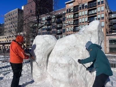people working on snow sculpture