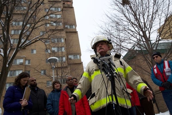 A fire official speaks at an outdoor news conference.