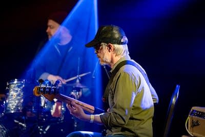 Two musicians performing onstage in a music venue