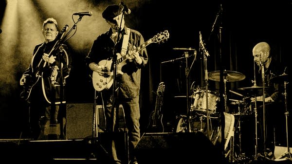 Drew Miller, Todd Menton, and Mo Engel perform onstage.