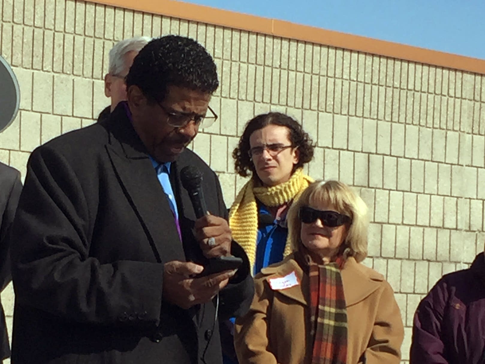 Bishop Richard Howell speaks at the dedication of a solar array.