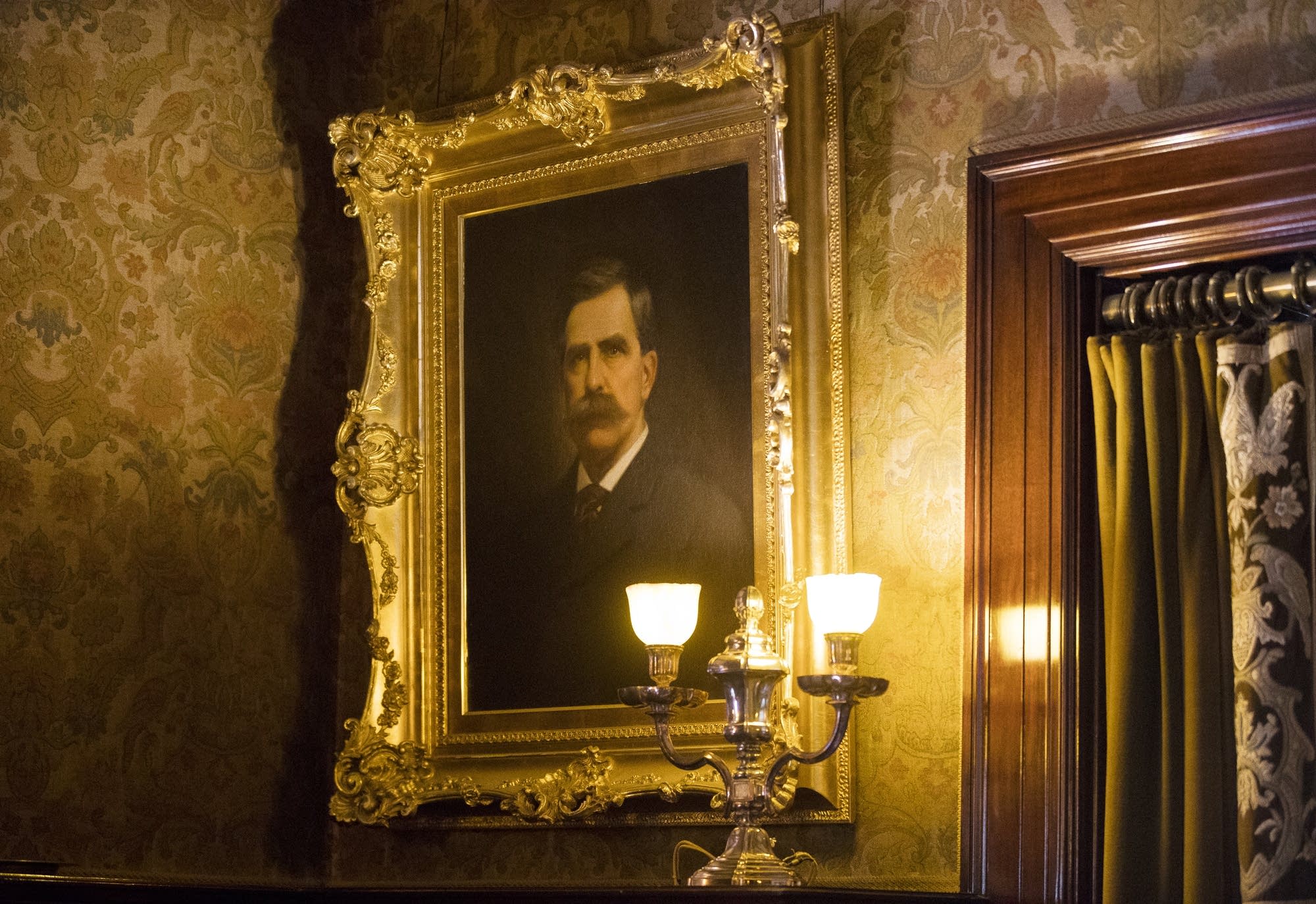 A portrait of Chester Congdon looks over visitors to the library.