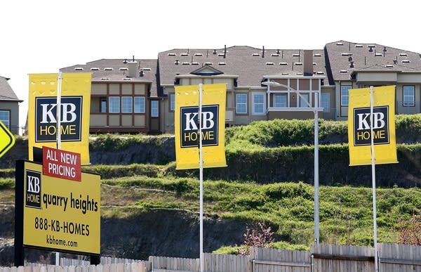 Signs are posted in front of new homes
