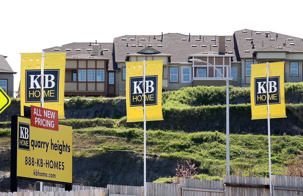 Signs are posted in front of new homes