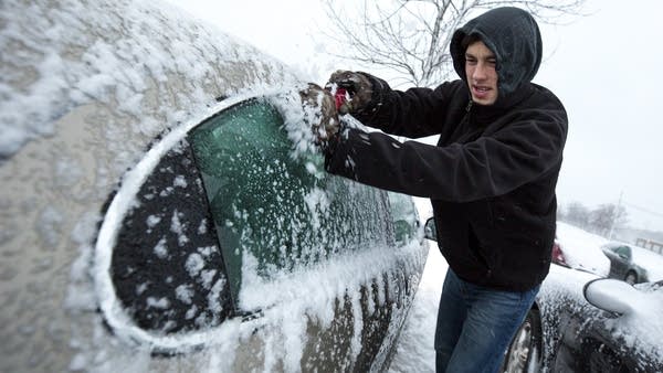 SCSU student Dalton Foley scrapes ice off his car.