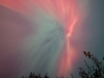 Green and red lights in the night sky.