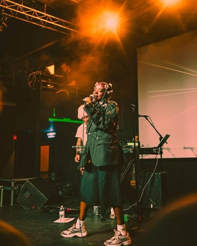 Dua Saleh sings into a microphone at Fine Line.