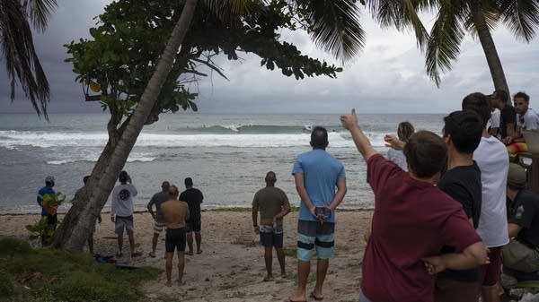 People gather at the coast hours before then-Tropical Storm Dorian enters in Patillas, Puerto Rico on, August 28, 2019. 