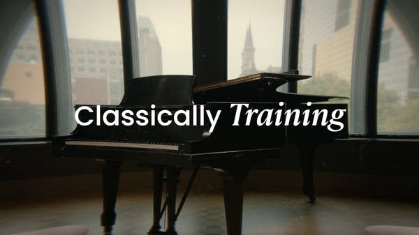 A grand piano rests by a window in a recording studio