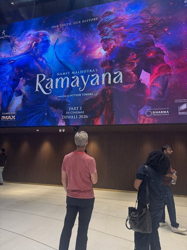 Nela and Kai looks at an ad for the Ramayana movie