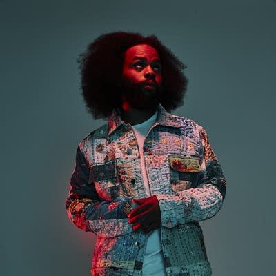 A man in a quilted jacket looks into the middle distance