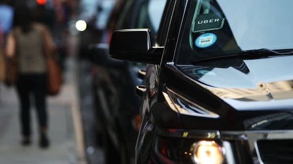 An Uber SUV waits for a client in Manhattan