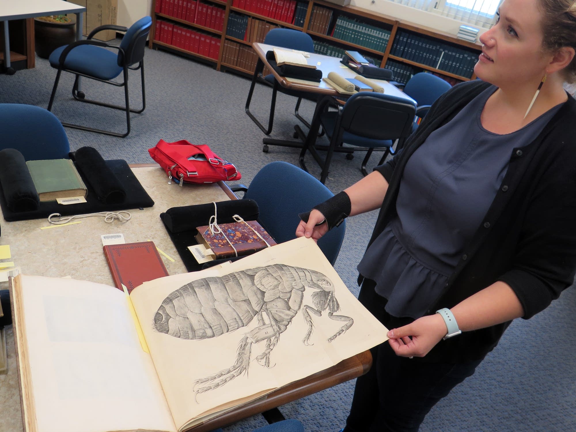 Curator Emily Beck shows a rare text.