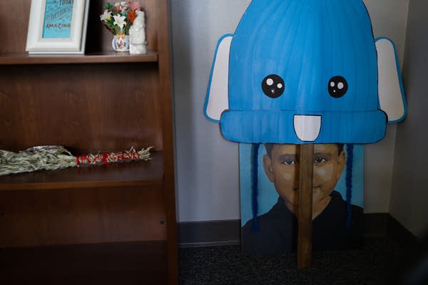 A poster of a young boy and a blue bunny hat