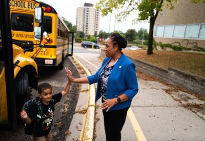 A student high fives a superintendent
