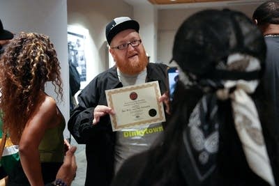 A man walks into a crowd after receiving an award