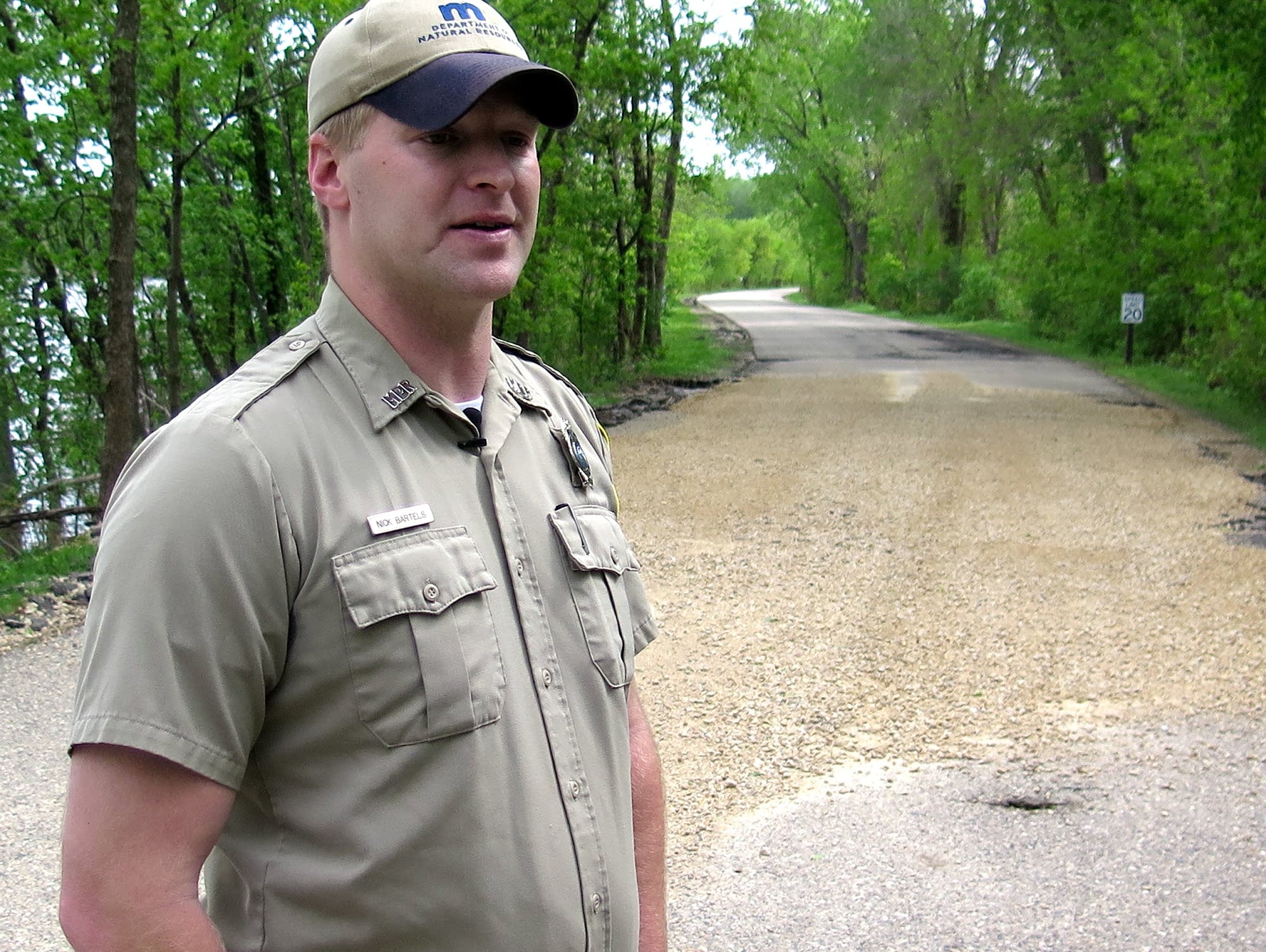 Nick Bartels stands in front of a gravel repair made to the park's road.