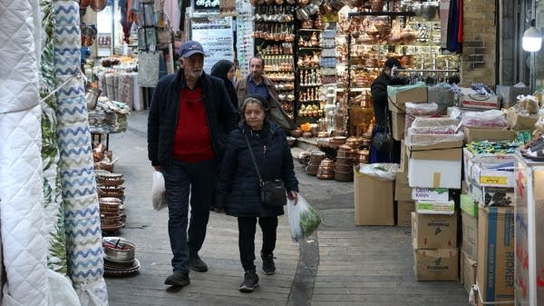 Above, Iranians shop at Tajrish Bazaar in Tehran on March 24. The Iranian government has been providing people with cash handouts, but it's barely enough to buy daily food, said Virginia Tech's Djavad Salehi-Isfahani.