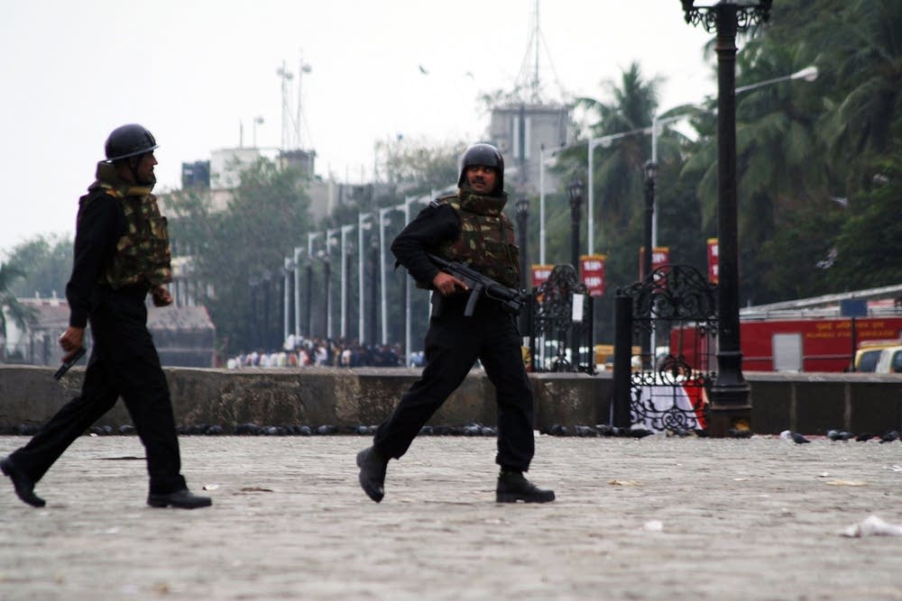 Military personnel take up positions at the Taj Ma