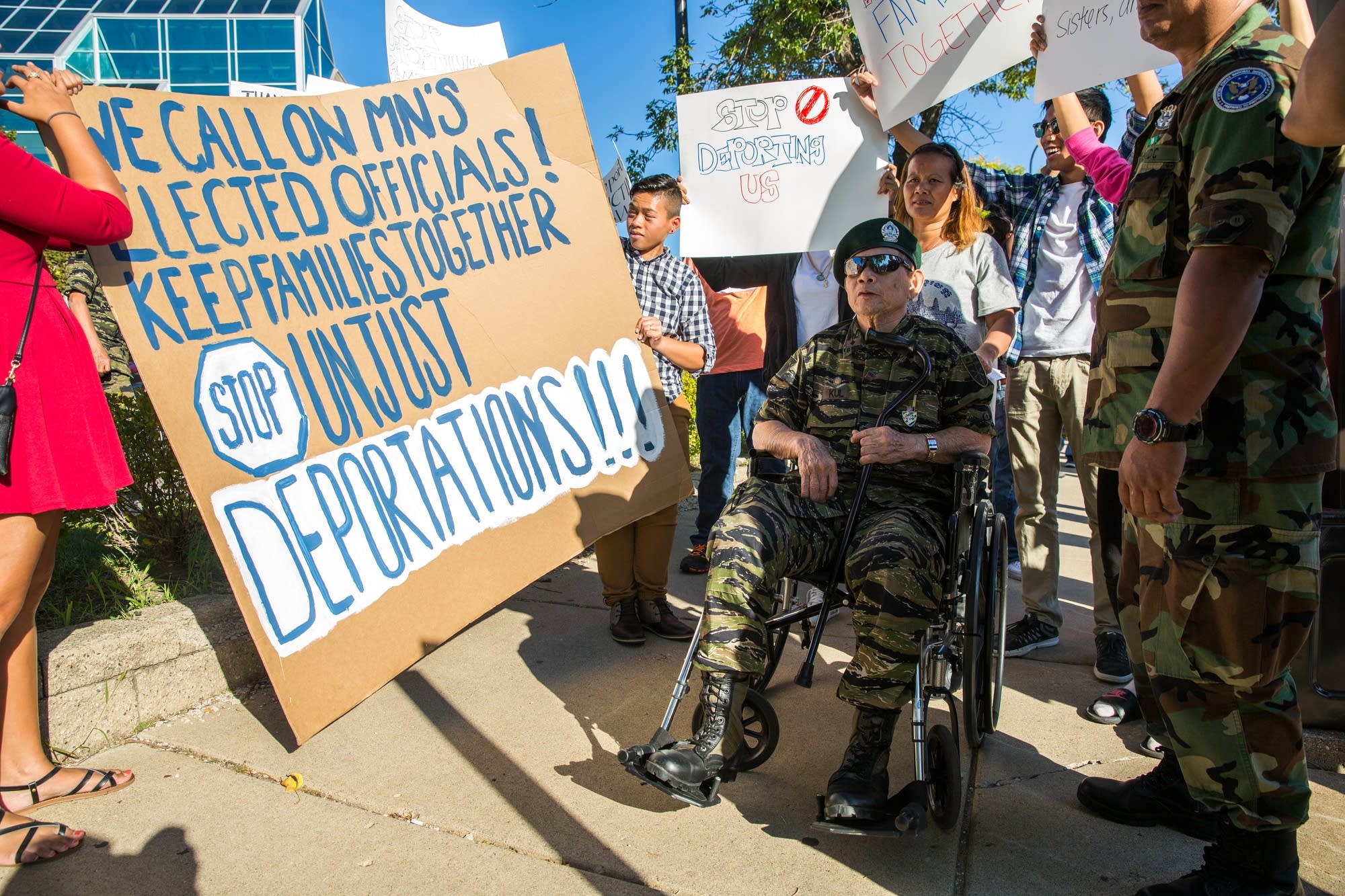 Protesters gather behind a TV broadcast.