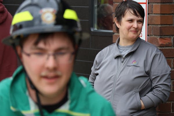 A person in a green shirt wearing a helmet