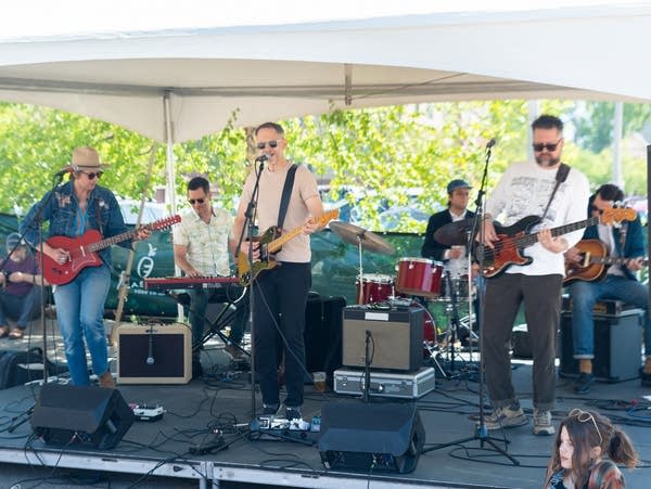 All Tomorrow's Petty perform on an outdoor stage.