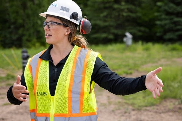A person wearing PPE talks