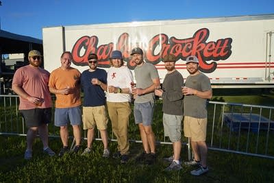 people posing for a photo at a charley crockett concert