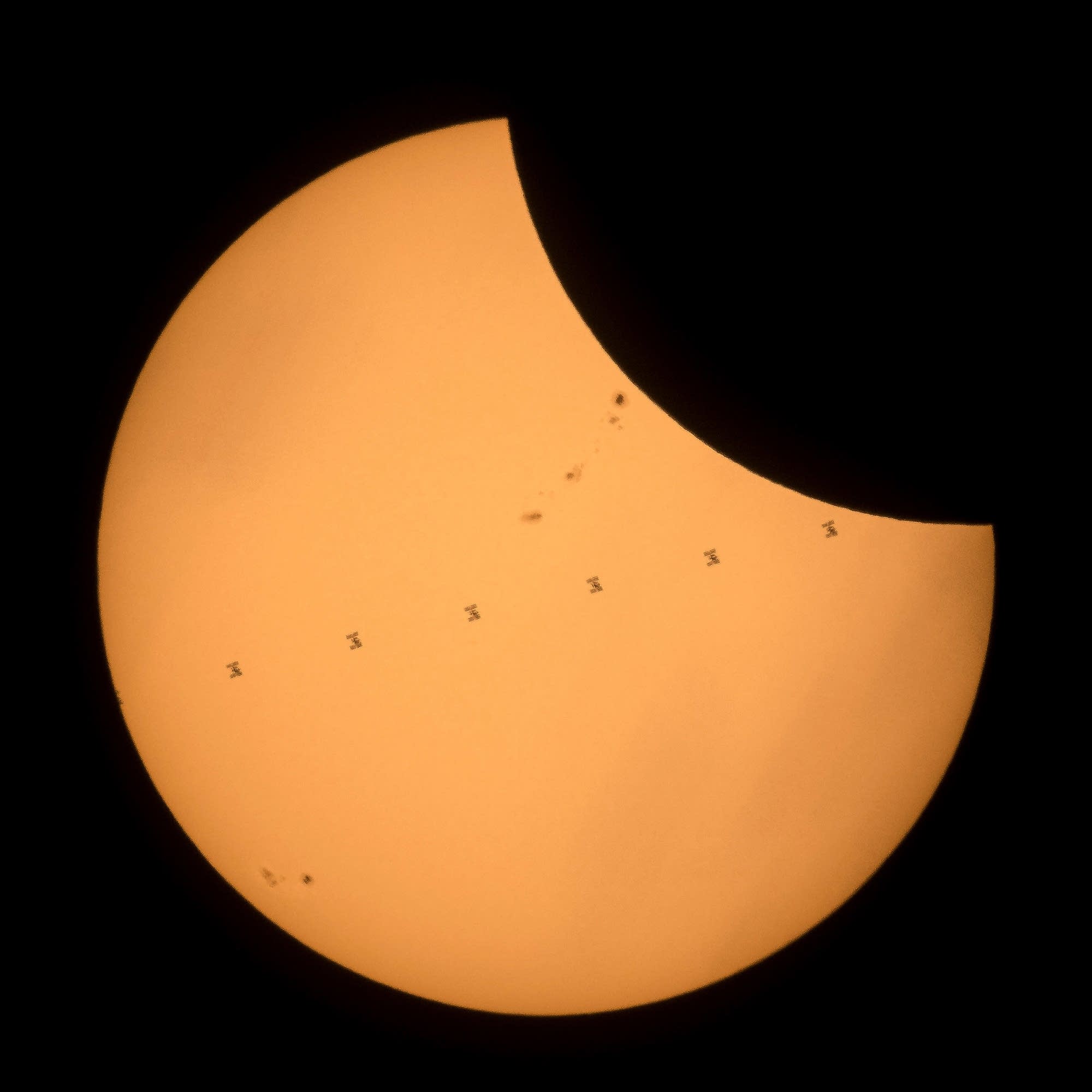 The International Space Station as it crosses the sun.
