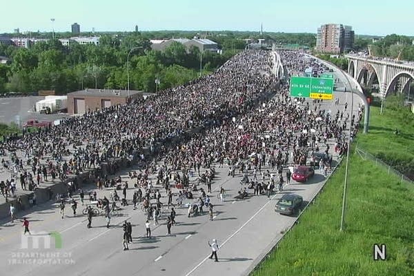 A crowd marches on the road